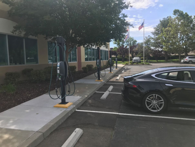 Car in parking lot with charging stations